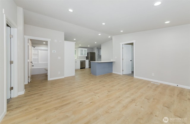 20215 Crystal Springs Dr, Granite Falls, WA 98252 - unfurnished living room featuring light wood-style flooring, baseboards, lofted ceiling, and recessed lighting
