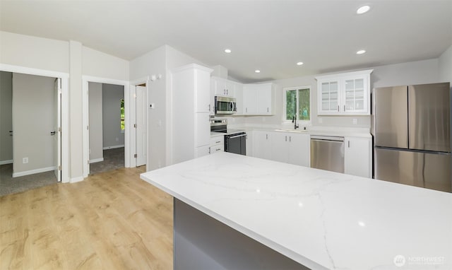 20215 Crystal Springs Dr, Granite Falls, WA 98252 - kitchen featuring stainless steel appliances, a sink, white cabinetry, glass insert cabinets, and light stone counters