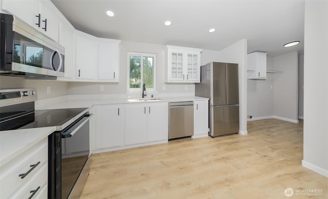 20215 Crystal Springs Dr, Granite Falls, WA 98252 - kitchen featuring stainless steel appliances, a sink, light wood-style floors, white cabinets, and baseboards