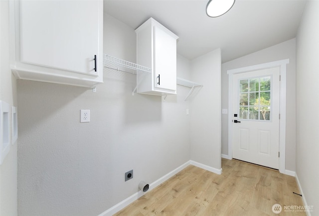 20215 Crystal Springs Dr, Granite Falls, WA 98252 - laundry room featuring electric dryer hookup, light wood-type flooring, cabinet space, and baseboards