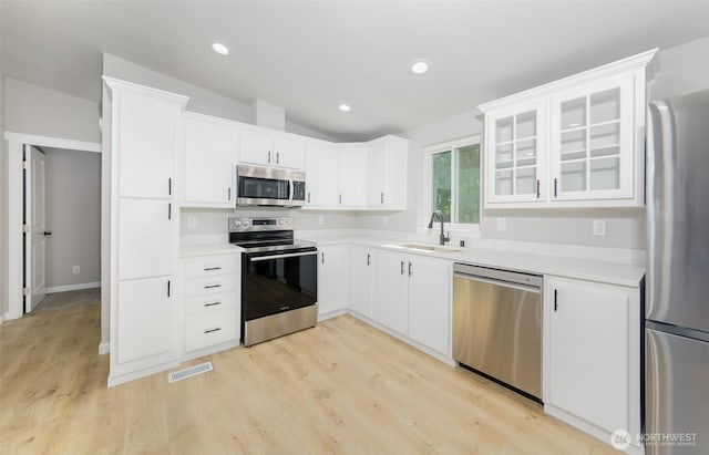 20215 Crystal Springs Dr, Granite Falls, WA 98252 - kitchen with stainless steel appliances, a sink, light wood-type flooring, light countertops, and lofted ceiling