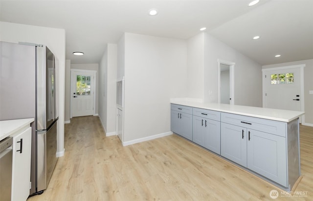 20215 Crystal Springs Dr, Granite Falls, WA 98252 - kitchen featuring a peninsula, light wood-style floors, appliances with stainless steel finishes, light countertops, and recessed lighting