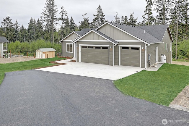 161 N Camano Ridge Rd, Camano Island, WA 98282 - view of front of house with an attached garage, driveway, board and batten siding, and a front yard
