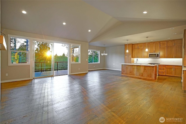 161 N Camano Ridge Rd, Camano Island, WA 98282 - unfurnished living room featuring baseboards, lofted ceiling, dark wood-style flooring, recessed lighting, and a chandelier