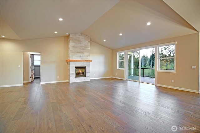 161 N Camano Ridge Rd, Camano Island, WA 98282 - unfurnished living room with lofted ceiling, wood finished floors, baseboards, a multi sided fireplace, and recessed lighting