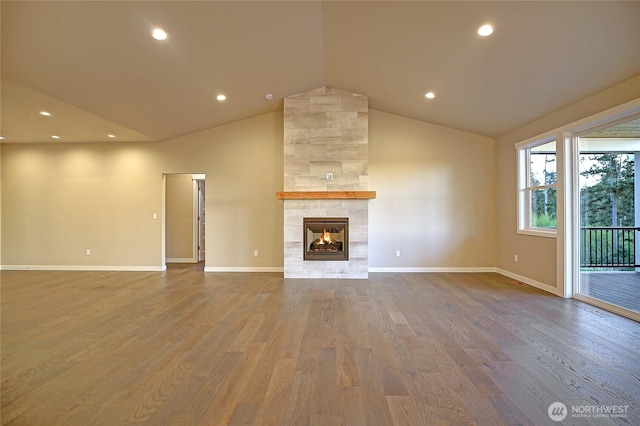 161 N Camano Ridge Rd, Camano Island, WA 98282 - unfurnished living room with a fireplace, wood finished floors, vaulted ceiling, baseboards, and recessed lighting
