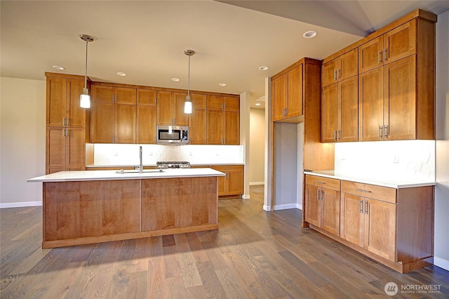 161 N Camano Ridge Rd, Camano Island, WA 98282 - kitchen with stainless steel microwave, brown cabinetry, a sink, stove, and recessed lighting
