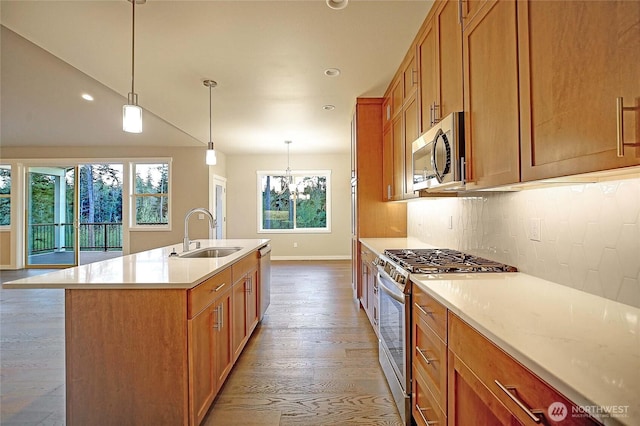 161 N Camano Ridge Rd, Camano Island, WA 98282 - kitchen with appliances with stainless steel finishes, a sink, baseboards, light countertops, and light wood finished floors
