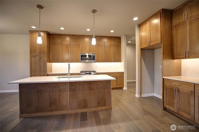 161 N Camano Ridge Rd, Camano Island, WA 98282 - kitchen featuring stainless steel microwave, a sink, brown cabinets, stove, and baseboards