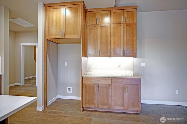 161 N Camano Ridge Rd, Camano Island, WA 98282 - kitchen with dark wood finished floors, baseboards, brown cabinetry, and backsplash