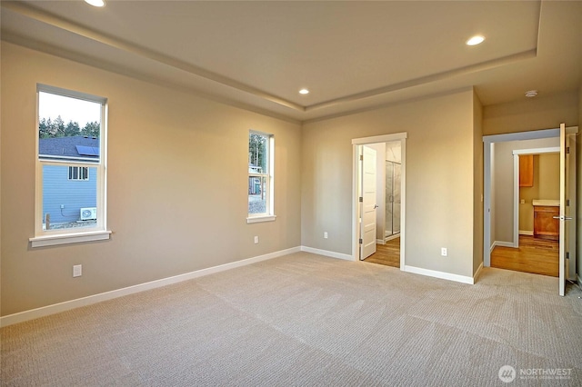 161 N Camano Ridge Rd, Camano Island, WA 98282 - unfurnished bedroom featuring recessed lighting, baseboards, light colored carpet, multiple windows, and a tray ceiling