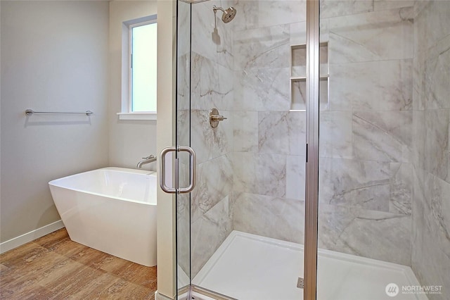161 N Camano Ridge Rd, Camano Island, WA 98282 - full bath featuring a shower stall, a soaking tub, wood finished floors, and baseboards