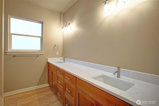 161 N Camano Ridge Rd, Camano Island, WA 98282 - bathroom with double vanity, wood finished floors, and baseboards