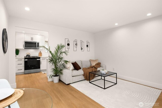 8535 16th Ave NW, Seattle, WA 98117 - living area featuring light wood-style flooring and recessed lighting
