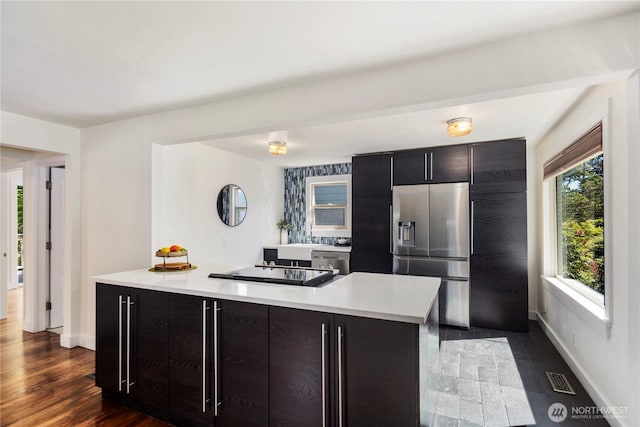 8414 9th Ave SW, Seattle, WA 98106 - kitchen with stainless steel appliances, light countertops, a kitchen island, baseboards, and modern cabinets