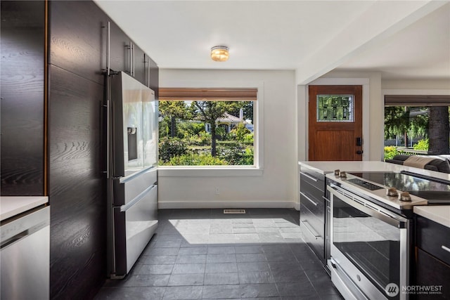 8414 9th Ave SW, Seattle, WA 98106 - kitchen with stainless steel appliances, baseboards, and light countertops