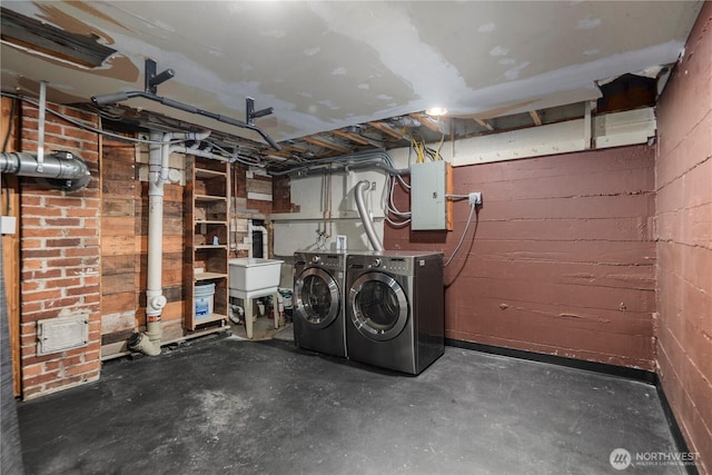 8414 9th Ave SW, Seattle, WA 98106 - unfinished below grade area featuring electric panel, washer and clothes dryer, concrete block wall, and a sink