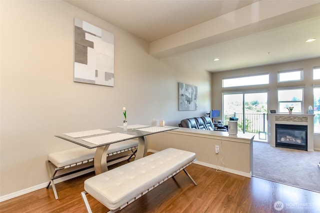 2311 Milton Way Unit F, Milton, WA 98354 - dining area with baseboards, wood finished floors, a glass covered fireplace, and recessed lighting