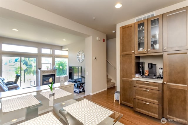 2311 Milton Way Unit F, Milton, WA 98354 - living room featuring a glass covered fireplace, stairs, wood finished floors, recessed lighting, and baseboards