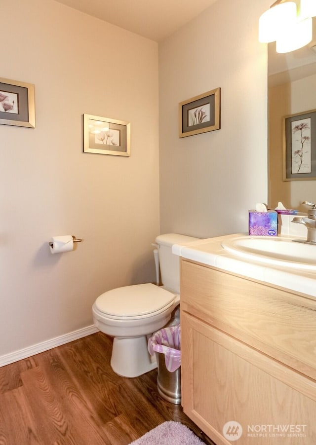 2311 Milton Way Unit F, Milton, WA 98354 - half bath with vanity, wood finished floors, toilet, and baseboards