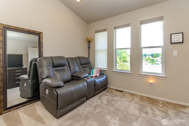 2311 Milton Way Unit F, Milton, WA 98354 - living area featuring light colored carpet, baseboards, and lofted ceiling