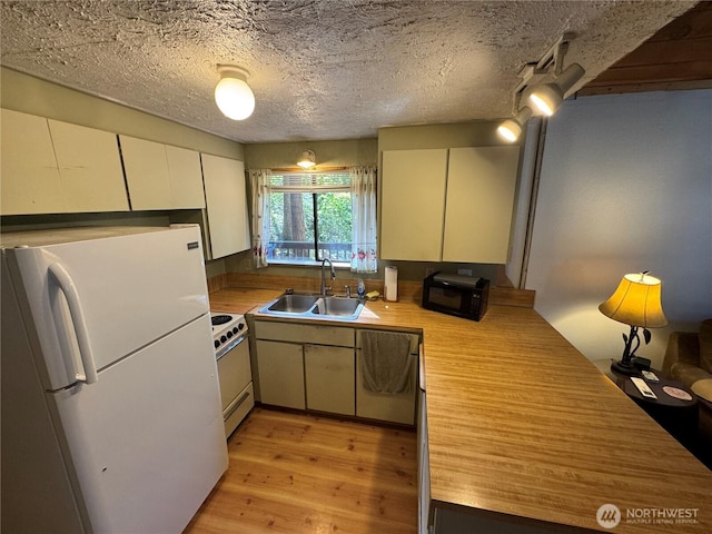 22337 Bluewater Dr SE, Yelm, WA 98597 - kitchen with white appliances, a sink, light wood-style flooring, and a textured ceiling