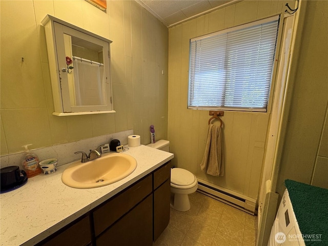 22337 Bluewater Dr SE, Yelm, WA 98597 - bathroom with baseboard heating, toilet, vanity, tile patterned floors, and a shower with shower curtain