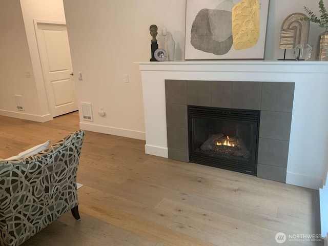 375 Kirkland Ave Unit 145, Kirkland, WA 98033 - detailed view of a tile fireplace, baseboards, and wood finished floors