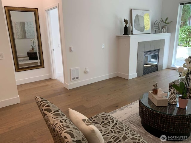 375 Kirkland Ave Unit 145, Kirkland, WA 98033 - living area with baseboards, wood finished floors, and a tile fireplace