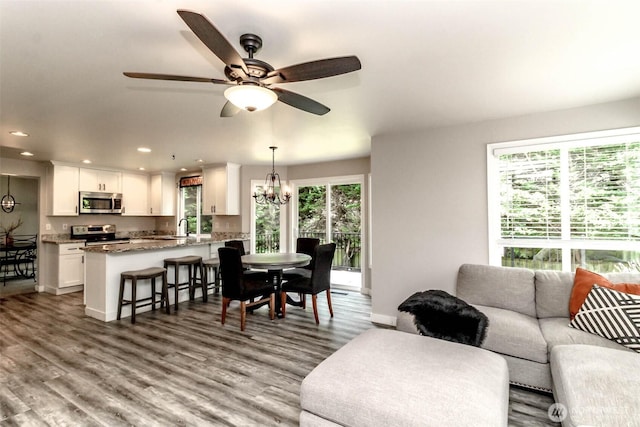 11608 SE 228th Pl, Kent, WA 98031 - living room featuring a chandelier, wood finished floors, recessed lighting, ceiling fan, and baseboards