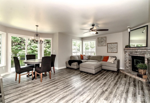 11608 SE 228th Pl, Kent, WA 98031 - living area with baseboards, a brick fireplace, light wood-type flooring, and a chandelier