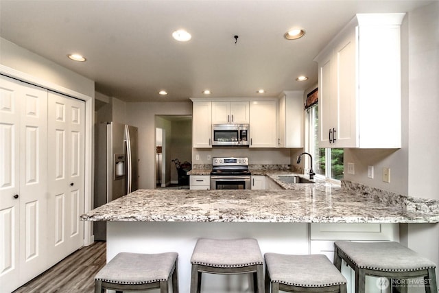 11608 SE 228th Pl, Kent, WA 98031 - kitchen featuring appliances with stainless steel finishes, a sink, a peninsula, recessed lighting, and white cabinets