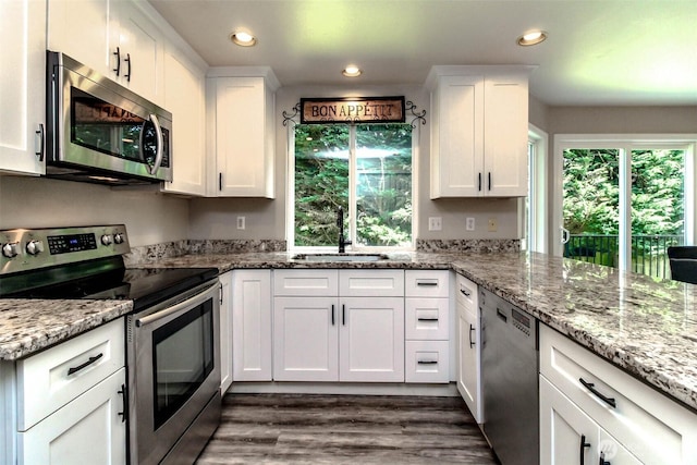 11608 SE 228th Pl, Kent, WA 98031 - kitchen with appliances with stainless steel finishes, a sink, white cabinets, dark wood-style flooring, and recessed lighting