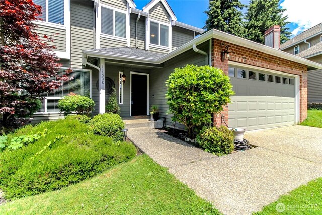 11608 SE 228th Pl, Kent, WA 98031 - view of front of house featuring a garage, driveway, and brick siding