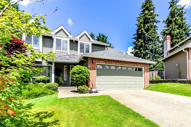 11608 SE 228th Pl, Kent, WA 98031 - traditional-style house featuring brick siding, an attached garage, a front yard, and roof with shingles