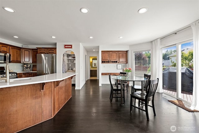 30101 129th Pl SE, Auburn, WA 98092 - kitchen featuring appliances with stainless steel finishes, recessed lighting, light countertops, a breakfast bar, and dark wood finished floors