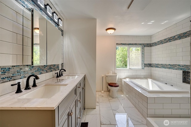 5530 Lewis River Rd, Ariel, WA 98603 - full bathroom featuring a bath, double vanity, marble finish flooring, toilet, and tile walls