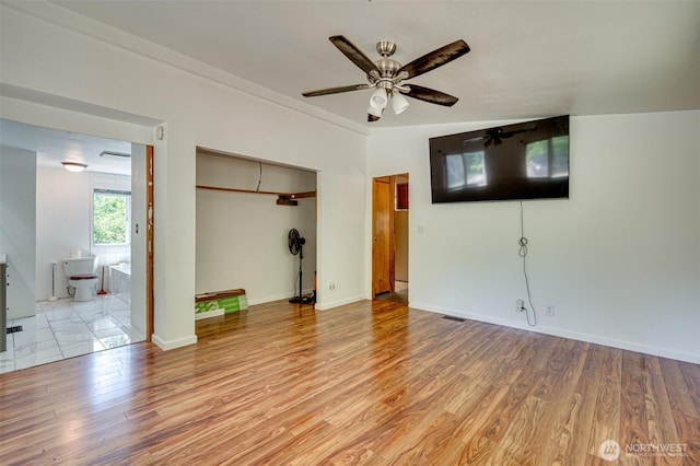 5530 Lewis River Rd, Ariel, WA 98603 - unfurnished living room featuring a ceiling fan, light wood-style floors, and baseboards