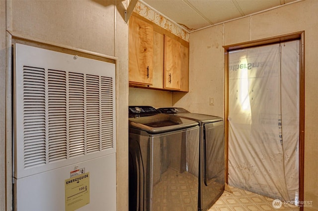 5530 Lewis River Rd, Ariel, WA 98603 - laundry area featuring a heating unit, cabinet space, and washing machine and clothes dryer