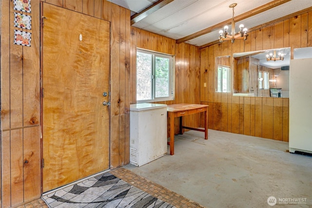 5530 Lewis River Rd, Ariel, WA 98603 - doorway to outside with a chandelier, wood walls, and concrete floors