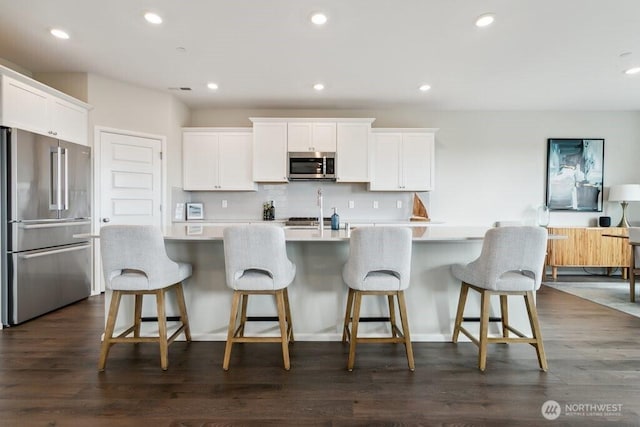 1134 Baker Heights Loop, Bremerton, WA 98312 - kitchen with appliances with stainless steel finishes, light countertops, white cabinets, decorative backsplash, and recessed lighting