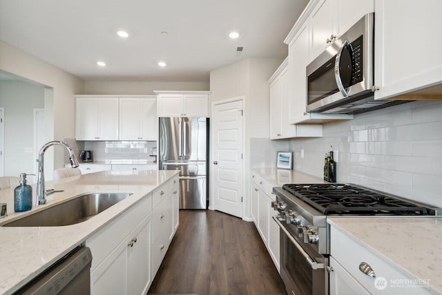 1134 Baker Heights Loop, Bremerton, WA 98312 - kitchen featuring appliances with stainless steel finishes, a sink, white cabinets, recessed lighting, and tasteful backsplash