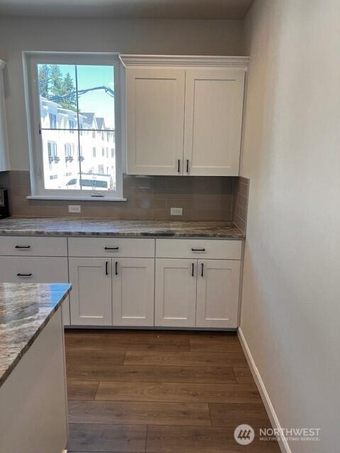 12084 126th Avenue Ct E Unit 72, Puyallup, WA 98374 - kitchen with white cabinetry, decorative backsplash, dark wood finished floors, and light stone countertops