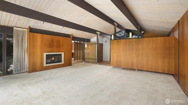 16 Riverview Dr NE, Auburn, WA 98002 - unfurnished living room with carpet floors, wood walls, wooden ceiling, and a glass covered fireplace