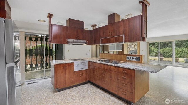 16 Riverview Dr NE, Auburn, WA 98002 - kitchen with stainless steel appliances, dark aggregate flooring, ventilation hood, and light stone countertops