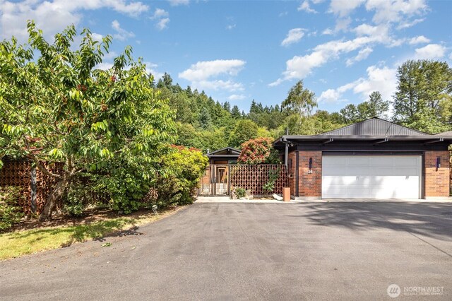 16 Riverview Dr NE, Auburn, WA 98002 - view of front of home with brick siding, asphalt driveway, a garage, and a gate