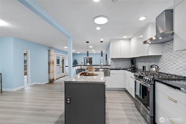 4530 240th St SW, Mountlake Terrace, WA 98043 - kitchen featuring gas range, wall chimney exhaust hood, light wood-type flooring, a center island, and a sink