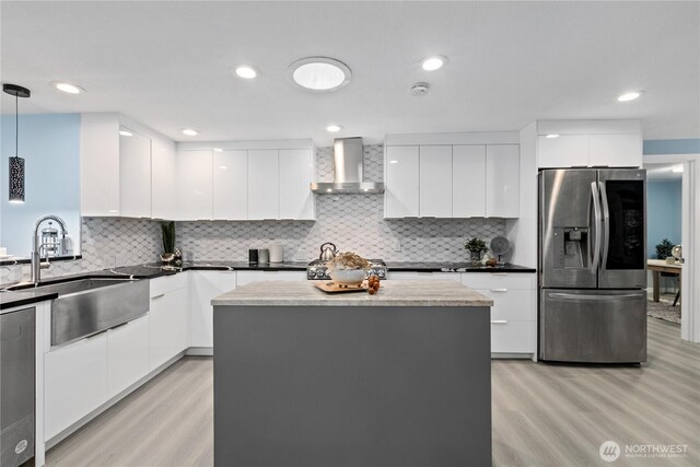 4530 240th St SW, Mountlake Terrace, WA 98043 - kitchen featuring appliances with stainless steel finishes, modern cabinets, wall chimney exhaust hood, a sink, and recessed lighting