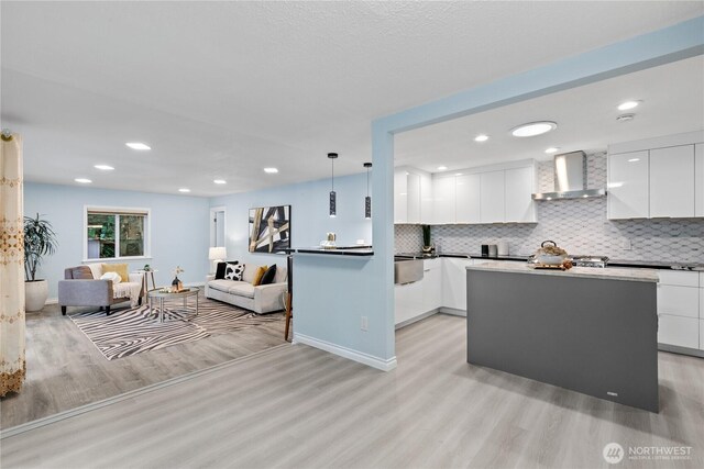 4530 240th St SW, Mountlake Terrace, WA 98043 - kitchen with wall chimney range hood, modern cabinets, light wood finished floors, open floor plan, and white cabinets