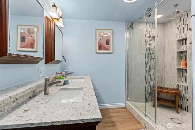 4530 240th St SW, Mountlake Terrace, WA 98043 - bathroom with double vanity, a stall shower, baseboards, and wood finished floors
